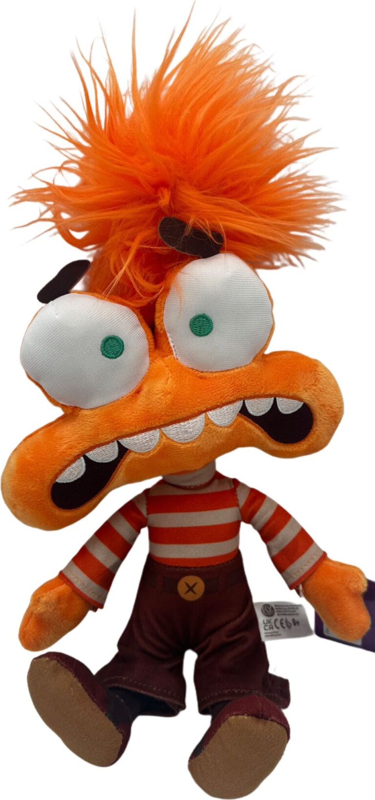 Orange Plüschfigur mit wilden Haaren und roten Streifen, breitem Mund und großen Augen. Orange Plüschfigur mit wilden Haaren und roten Streifen, breitem Mund und großen Augen.