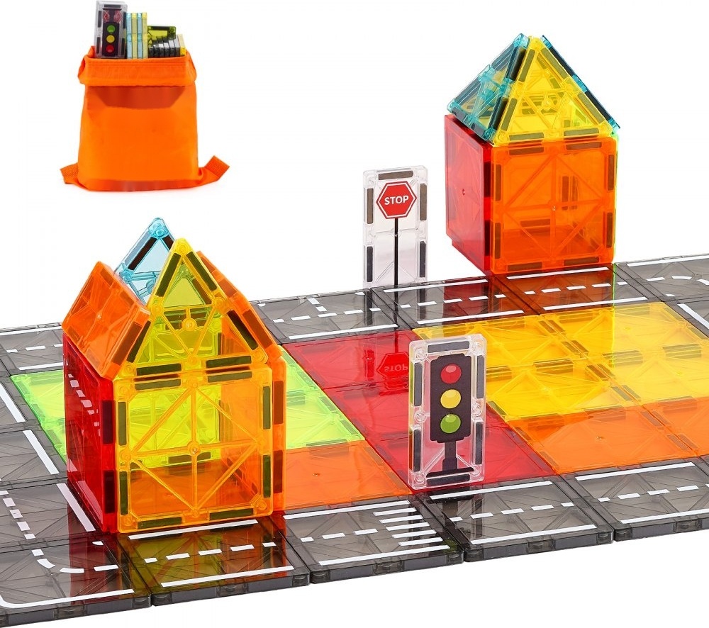 Bunte magnetische Bausteine bilden Häuser und Straßen mit Verkehrszeichen und Ampeln.