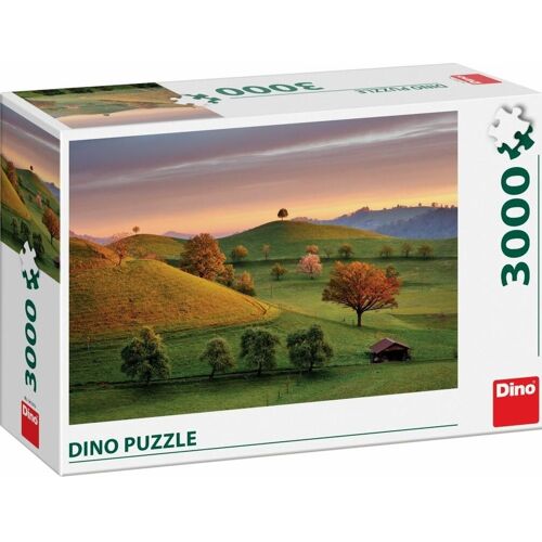 Puzzle-Schachtel mit Landschaftsmotiv von grünen Hügeln bei Sonnenuntergang. Puzzle-Schachtel mit Landschaftsmotiv von grünen Hügeln bei Sonnenuntergang.