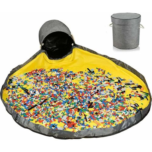 Gelbe Spielmatte mit bunten Bausteinen und grauer Aufbewahrungstasche daneben. Gelbe Spielmatte mit bunten Bausteinen und grauer Aufbewahrungstasche daneben.