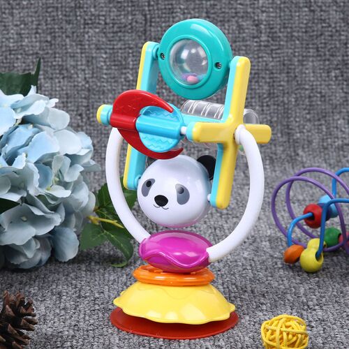 Buntes Babyspielzeug mit Panda-Motiv und Drehelementen auf grauem Teppich. Buntes Babyspielzeug mit Panda-Motiv und Drehelementen auf grauem Teppich.