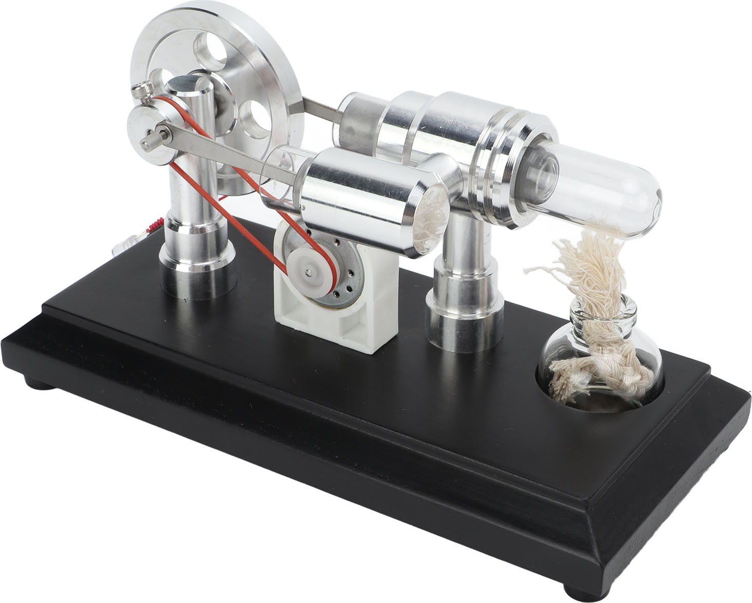 Modell-Stirlingmotor aus Metall auf schwarzem Sockel, mit Glasbehälter und Docht.